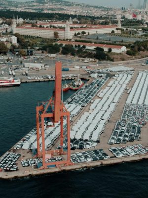 Aerial view of a bustling car shipping terminal in Istanbul, Türkiye, showcasing a busy port with vehicles ready for export.