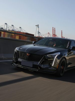 Capture of a black Cadillac CT6 in dynamic motion on an urban highway.